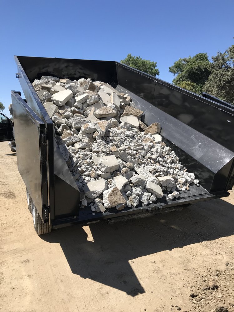 Dumpster loaded with broken concrete debris