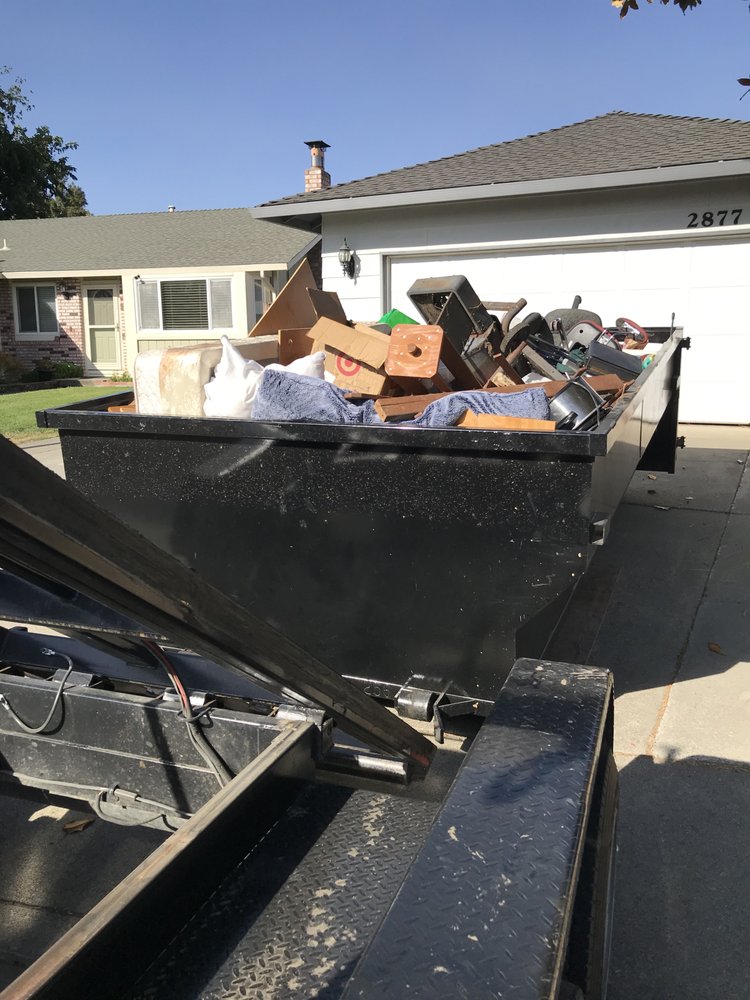 Loaded dumpster on a home driveway